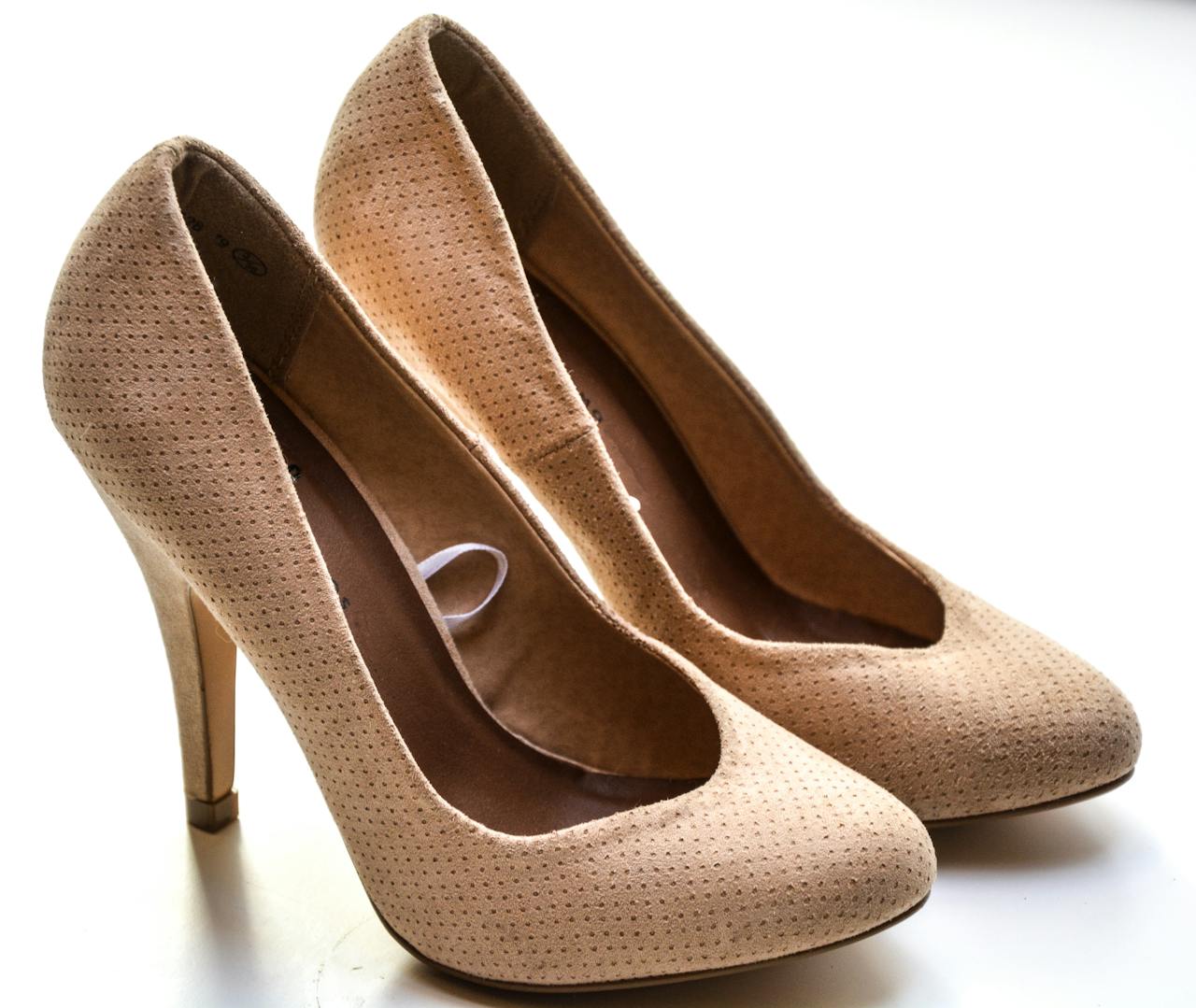 Stylish beige stiletto high heels with a textured leather design, perfect for fashion-forward elegance.